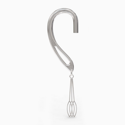 Angled shot of silver dangle cuff showcasing swing pendant
