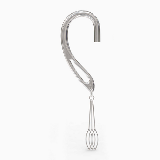 Angled shot of silver dangle cuff showcasing swing pendant